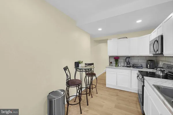 a kitchen with a sink cabinets and window