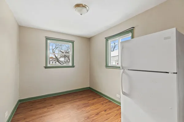 a view of empty room with closet and wooden floor