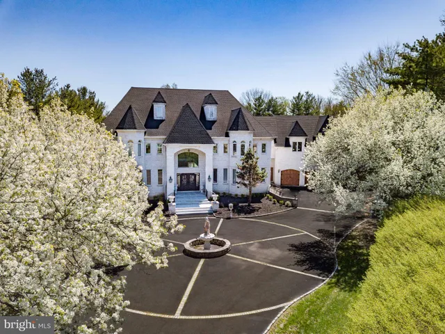 a view of a patio with chairs and potted plants