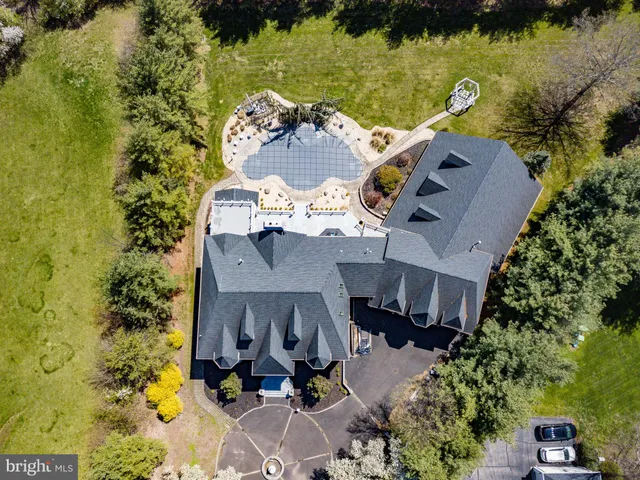 an aerial view of a house with a yard basket ball court and outdoor seating