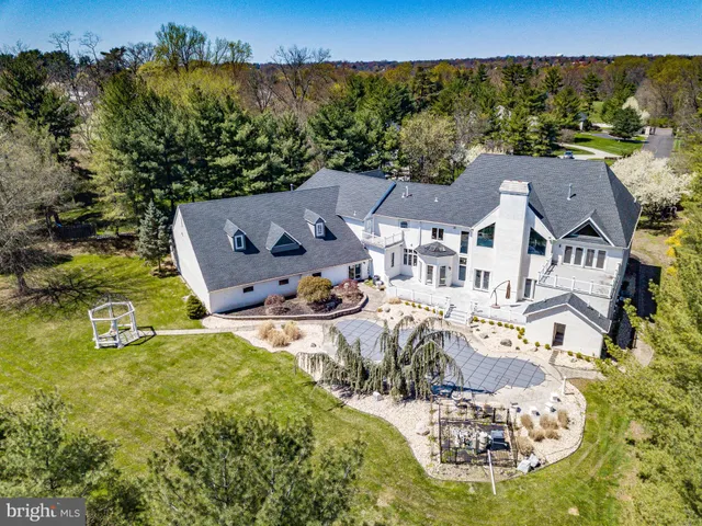 an aerial view of a house with yard swimming pool and outdoor seating