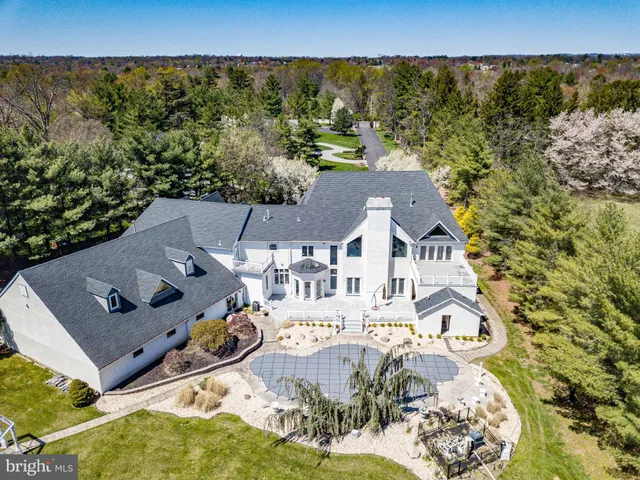 an aerial view of a house with yard swimming pool and outdoor seating