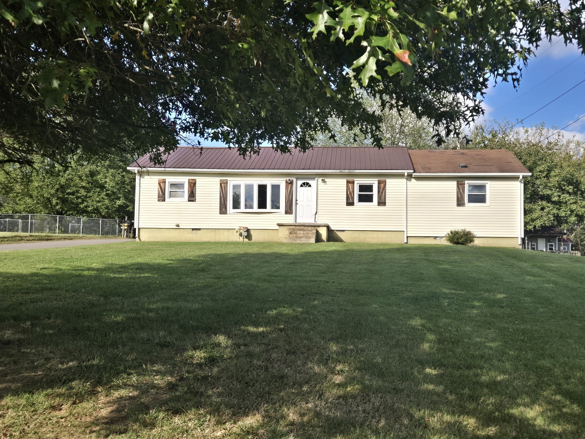 a front view of house with yard and green space