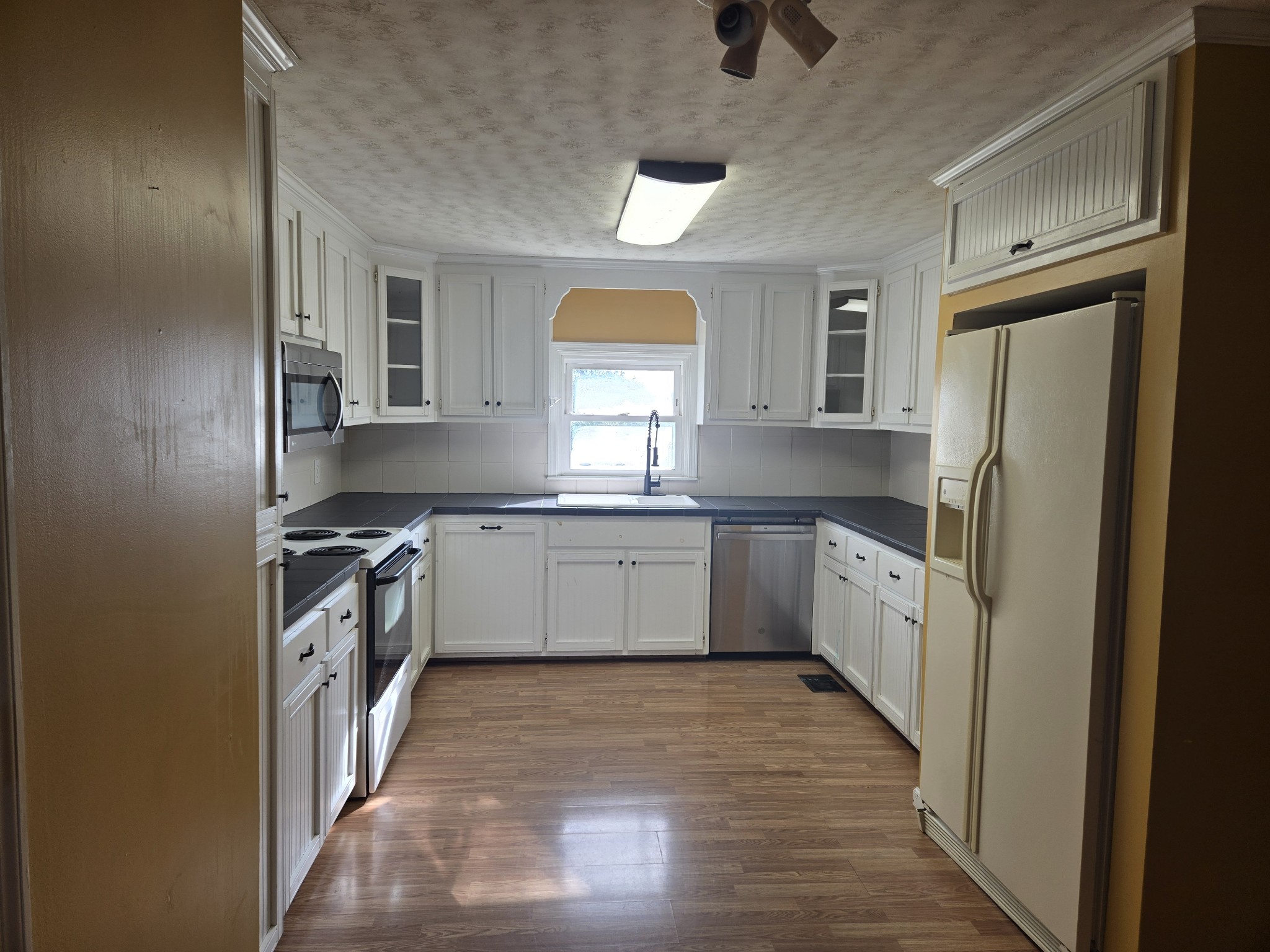 4671 Talley Road Springfield, TN 37172 - Photo 6 of 19 a kitchen with a white cabinets and white appliances