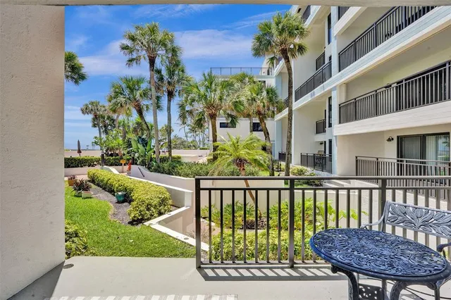 a view of a house with a small yard and wooden fence
