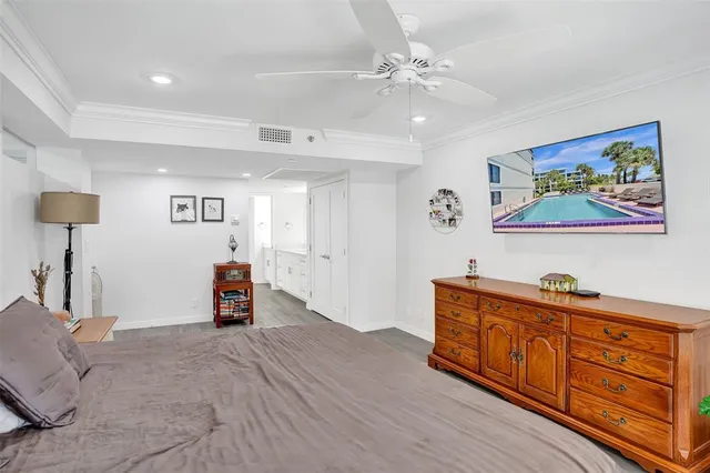 a view of a bedroom with furniture and wooden floor
