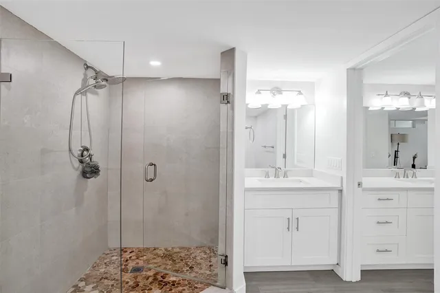 a bathroom with a shower sink and mirror