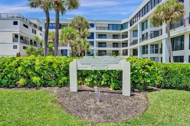 a front view of a building with a garden