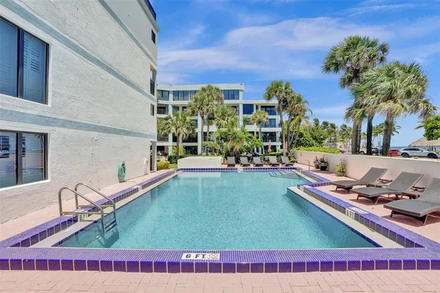 a view of a swimming pool with a lounge chairs