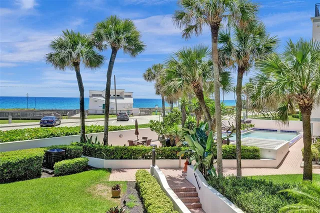 a view of a garden with a building in the background