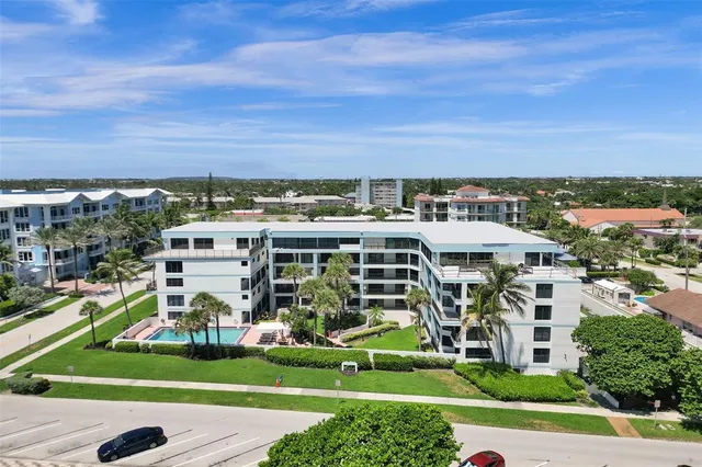 a view of a big yard with lawn chairs