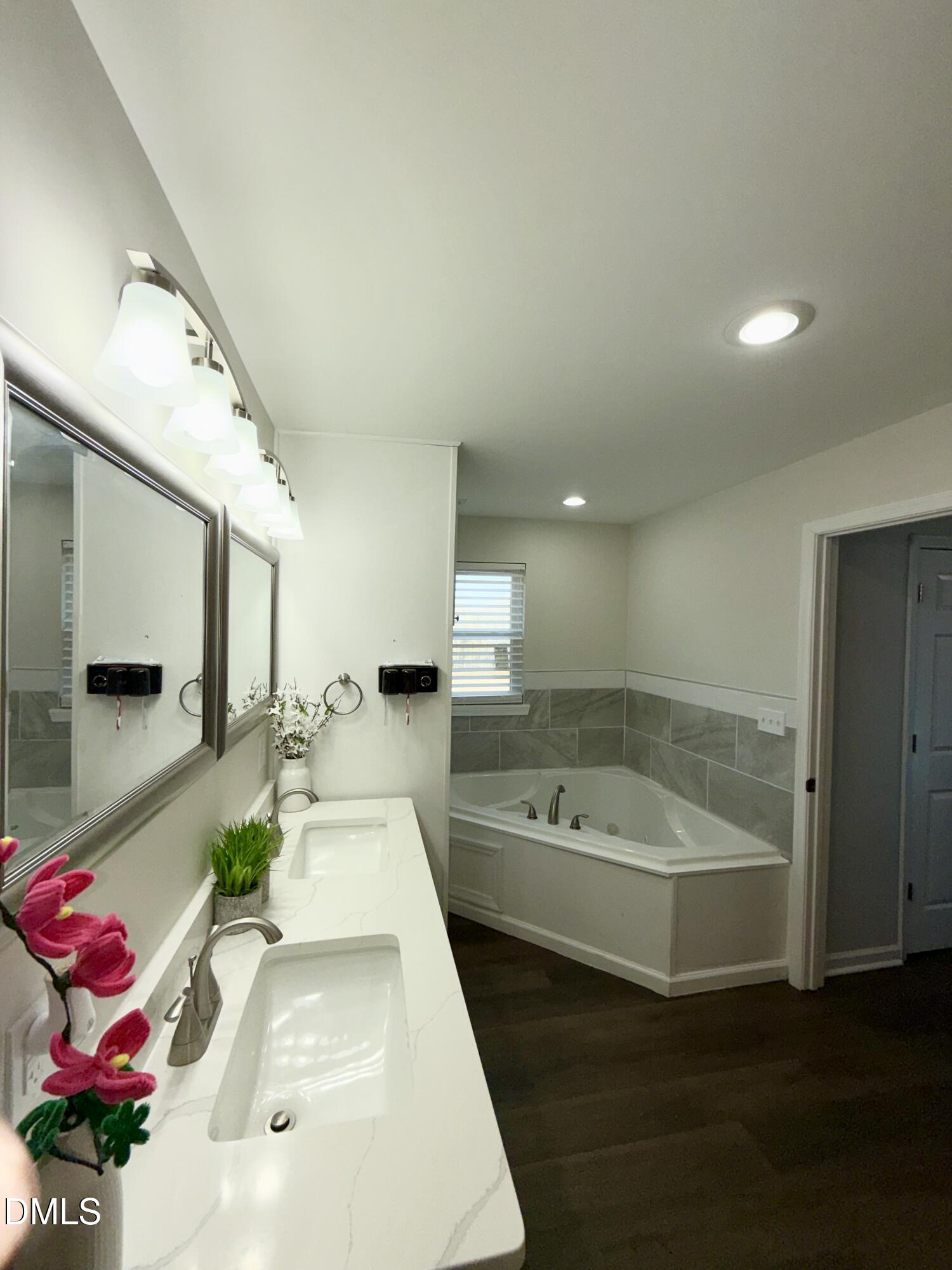 1696 James Winston Road Oxford, NC 27565 - Photo 16 of 19 a bathroom with a tub sink and mirror