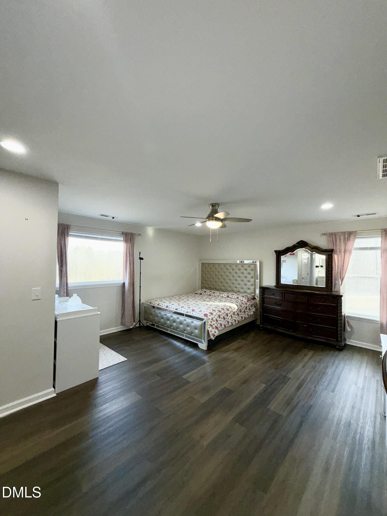 1696 James Winston Road Oxford, NC 27565 - Photo 17 of 19 a spacious bedroom with a bed and a couch