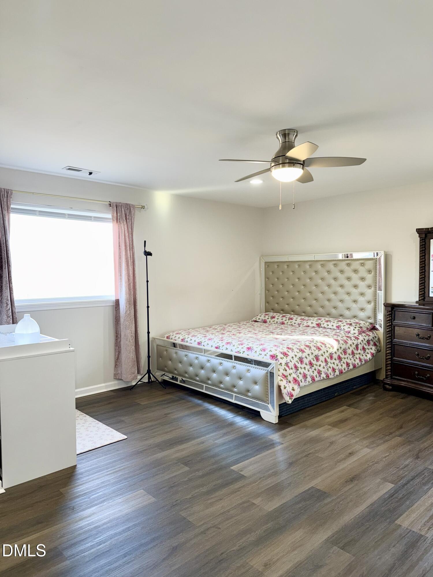 1696 James Winston Road Oxford, NC 27565 - Photo 18 of 19 a bedroom with a bed and a chandelier