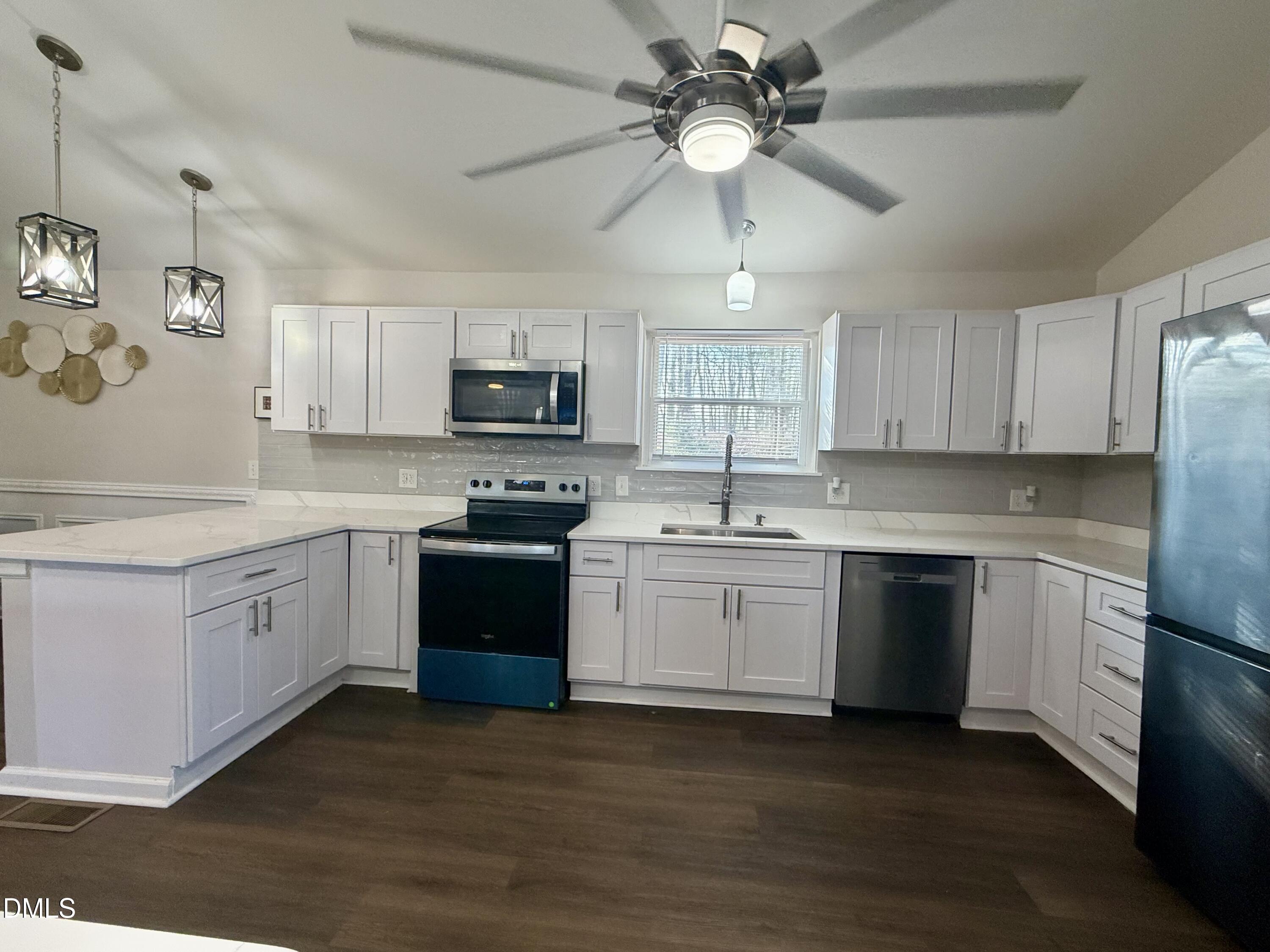 1696 James Winston Road Oxford, NC 27565 - Photo 7 of 19 a kitchen with stainless steel appliances granite countertop a stove sink microwave and refrigerator