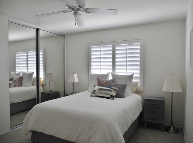 a bedroom with bed and a chandelier