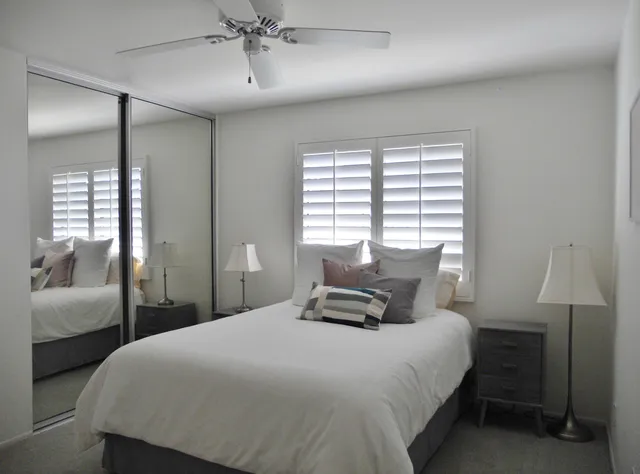 a bedroom with bed and a chandelier