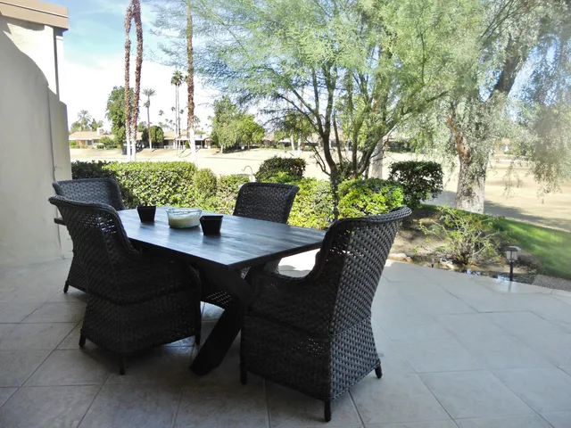 a view of a hallway with wooden floor door and windows