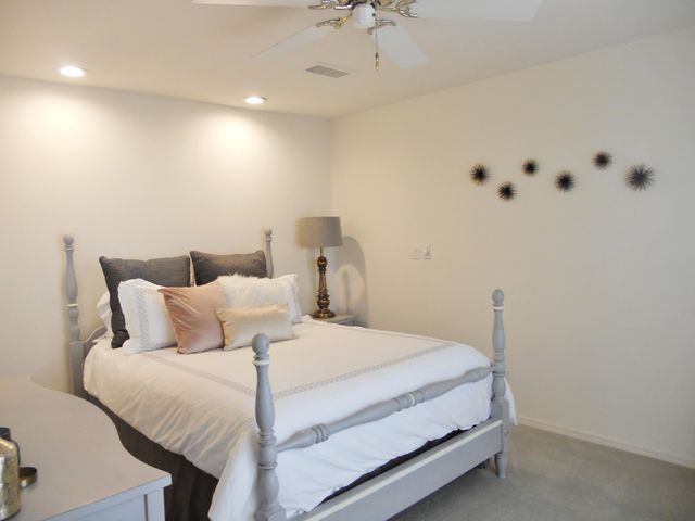 a bathroom with a granite countertop sink mirror vanity and toilet
