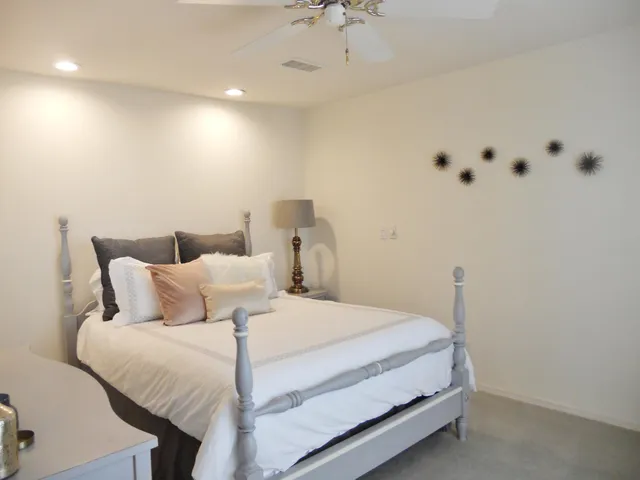 a bathroom with a granite countertop sink mirror vanity and toilet