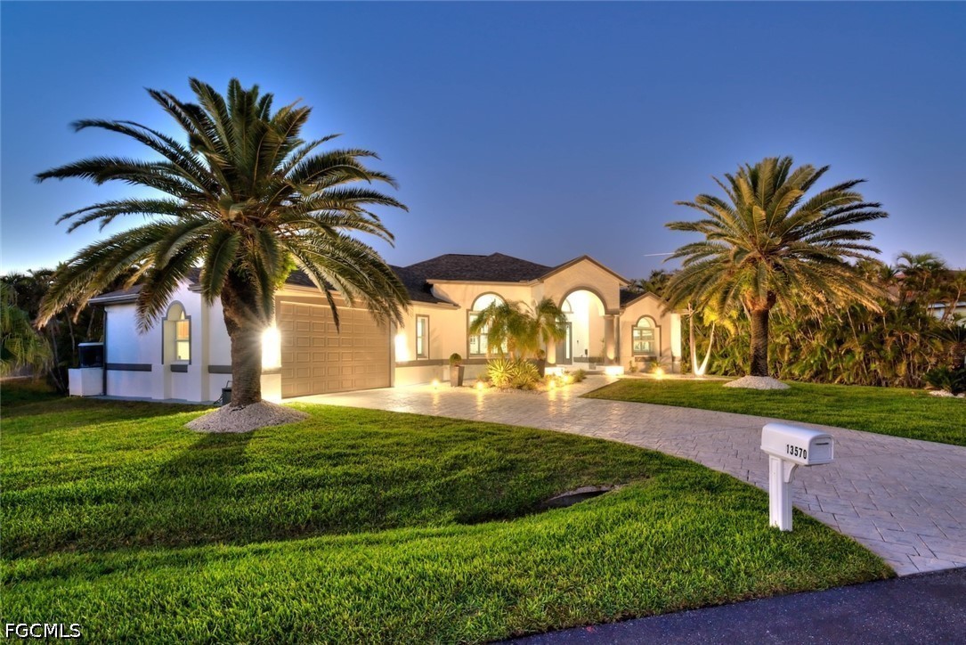 13570 Harbour Ridge Drive Fort Myers, FL 33908 - Photo 43 of 50 a view of a house with a big yard and palm trees