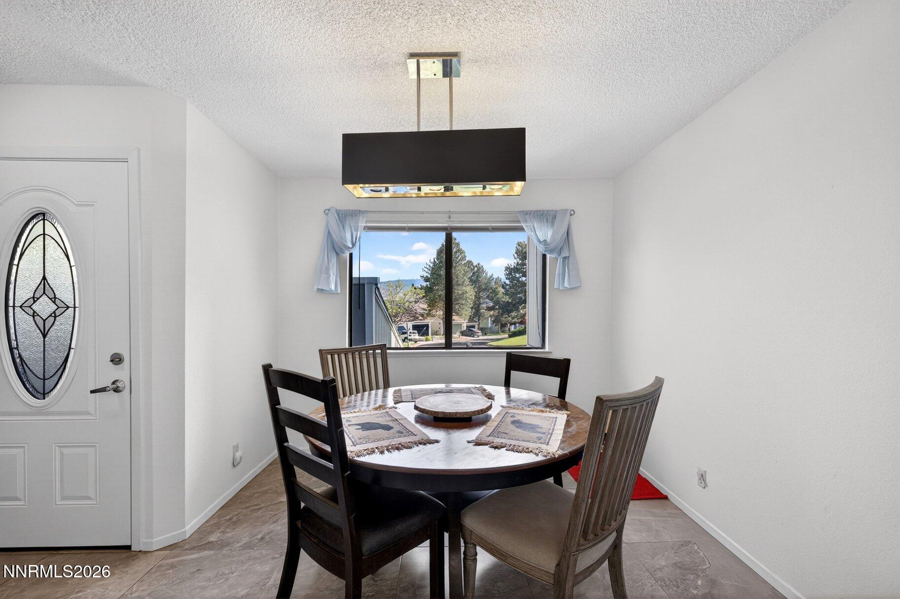 3415 Balboa Drive Reno, NV 89503 - Photo 9 of 61 a view of a dining room with furniture window and outside view