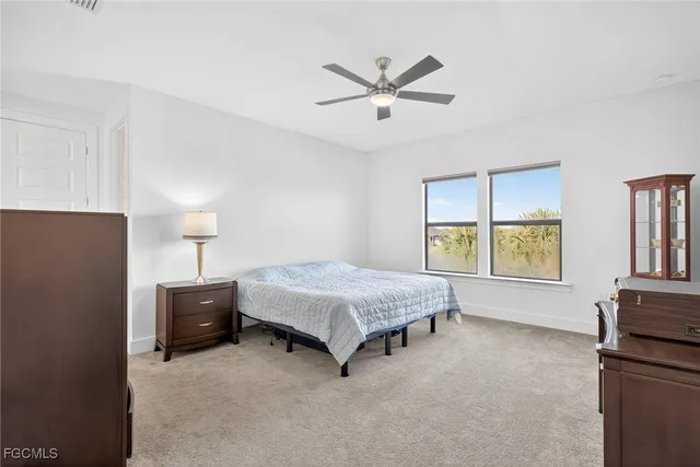 a spacious bedroom with a bed and window