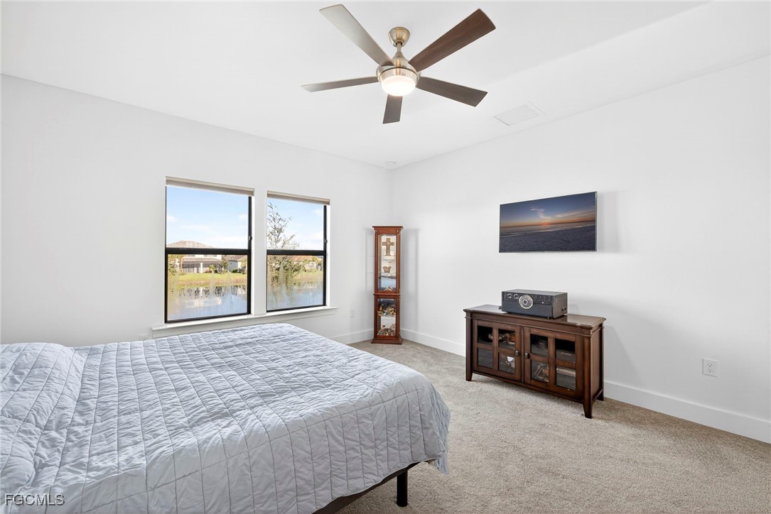 4351 Washington Place Ave Maria, FL 34142 - Photo 18 of 44 a bedroom with a bed and a flat screen tv