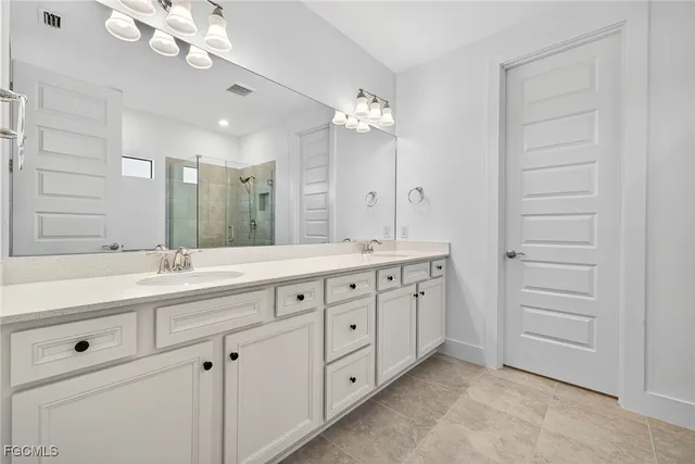 a bathroom with a double vanity sink and a mirror