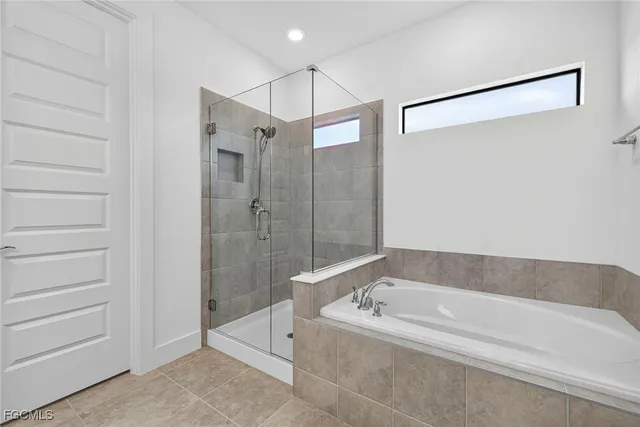 a bathroom with a bathtub and a shower