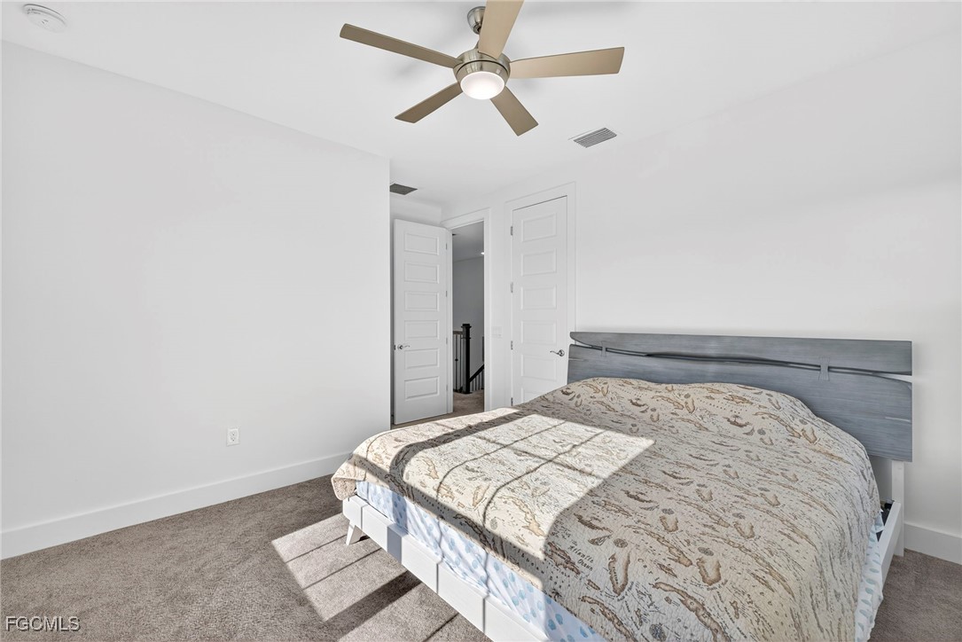 4351 Washington Place Ave Maria, FL 34142 - Photo 28 of 44 a bedroom with a bed and a ceiling fan