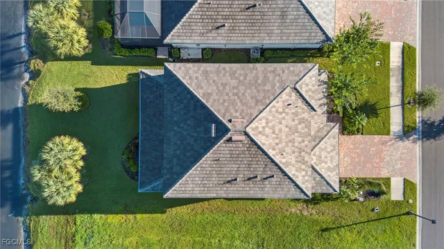 an aerial view of residential houses with outdoor space and river