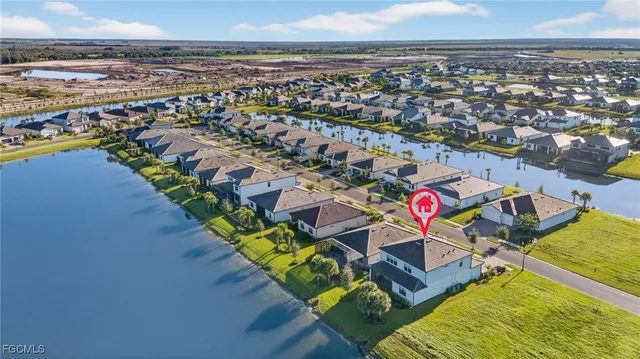 an aerial view of residential houses with outdoor space and swimming pool