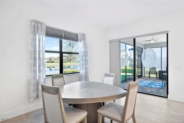 a view of a a dining room with furniture window and wooden floor