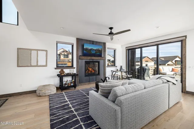 a living room with furniture a fireplace and a flat screen tv