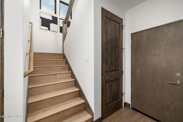 a view of entryway with wooden floor and stairs