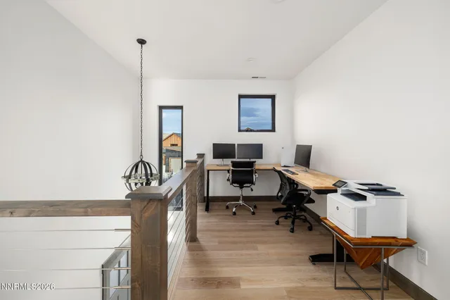 a view of a workspace with furniture and a window