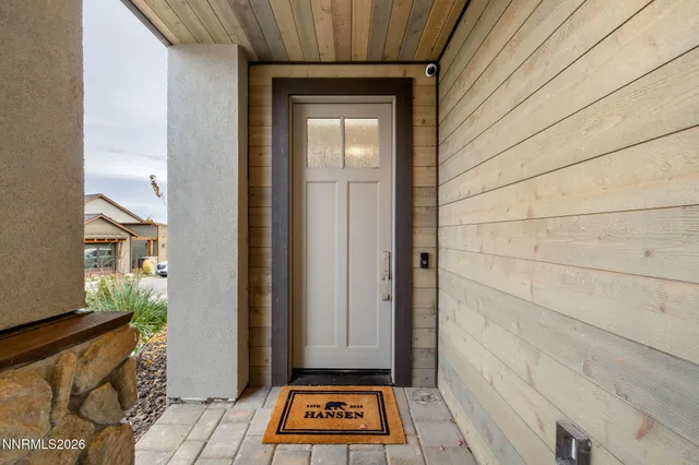 a view of a room that has a door and wooden floor