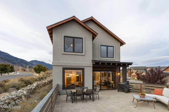a front view of a house with a yard and balcony