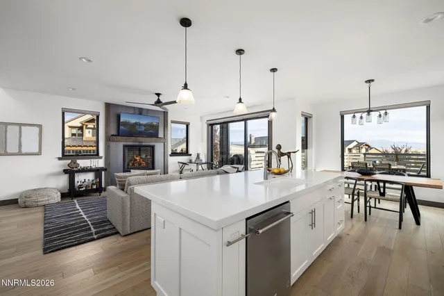 a large kitchen with kitchen island a stove a sink a counter space and a fireplace
