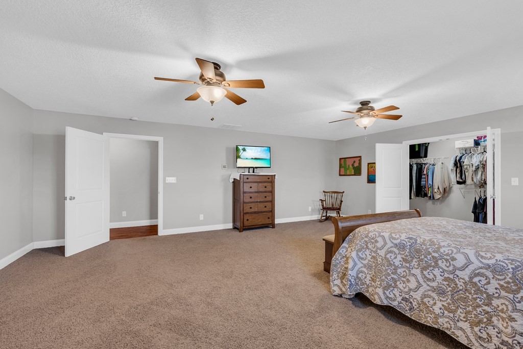 465 Hickory Lane Sparta, TN 38583 - Photo 41 of 46 a bedroom with a bed and ceiling fan