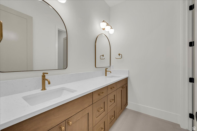 1620 Belayer Drive St. George, UT 84770 - Photo 34 of 51 Dual vanity featuring a wood-finish cabinet, white countertop, and gold-finish fixtures