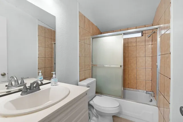 a bathroom with a sink toilet and shower