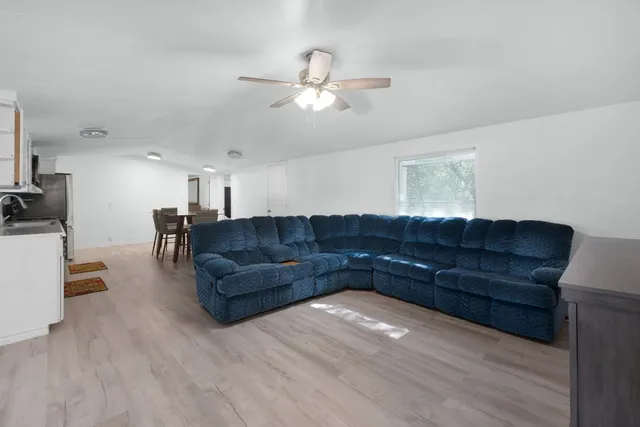a living room with couches and furniture with wooden floor