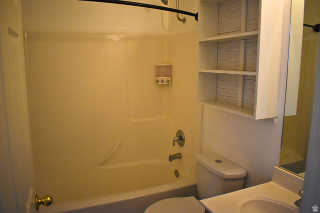 3327 East Windhover Road Eagle Mountain, UT 84005 - Photo 13 of 38 Bathroom featuring a white bathtub with a shower combination, toilet, and vanity with an integrated sink