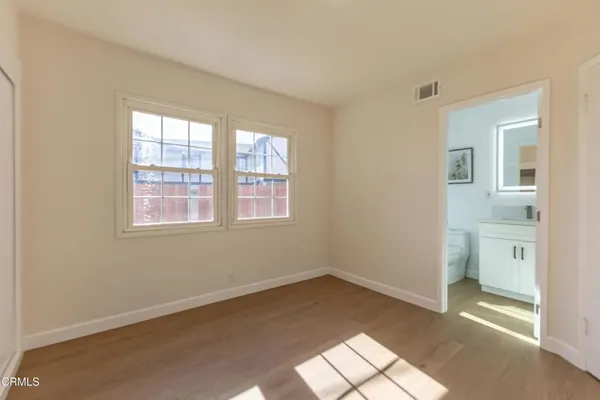 an empty room with windows and closet