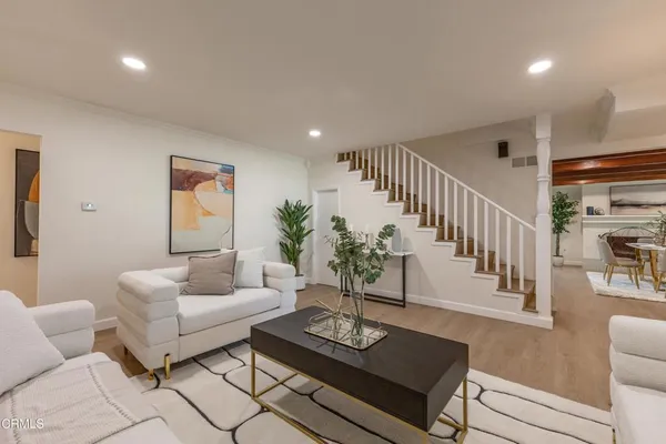 a view of a dining room with furniture and a potted plant