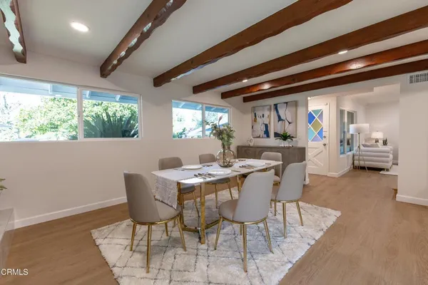 a kitchen with granite countertop white cabinets and white stainless steel appliances