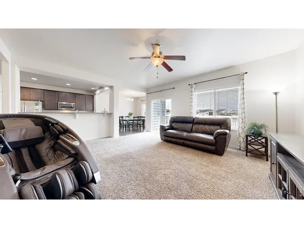 a living room with furniture and a chandelier