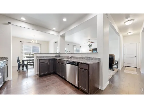 a kitchen with stainless steel appliances kitchen island granite countertop a stove a sink and a refrigerator